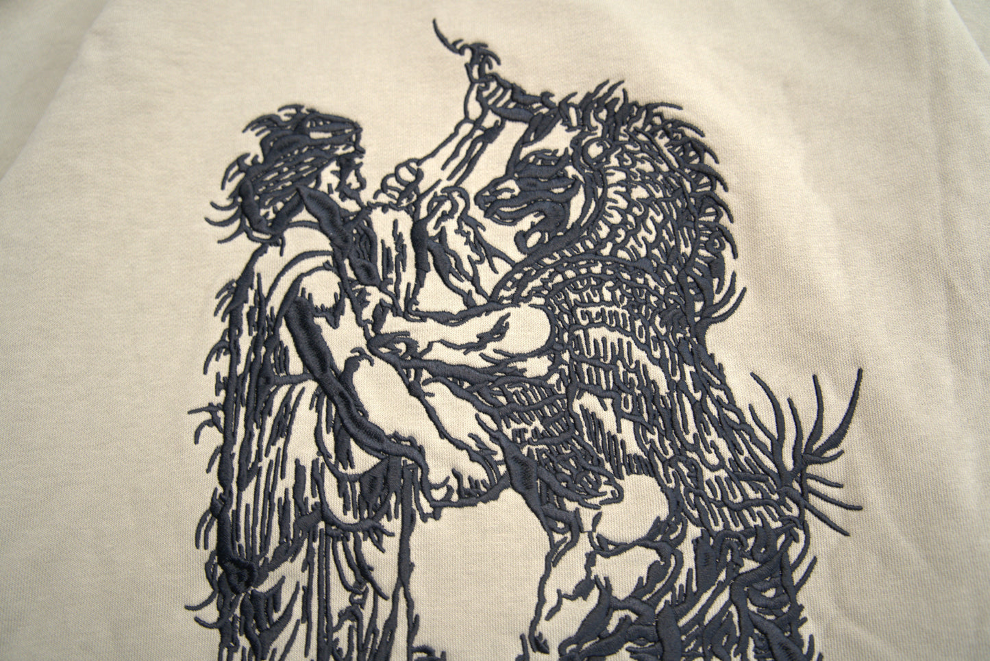 100,000 stitch Zoroastrian symbolic embroidery detail on heavyweight hoodie