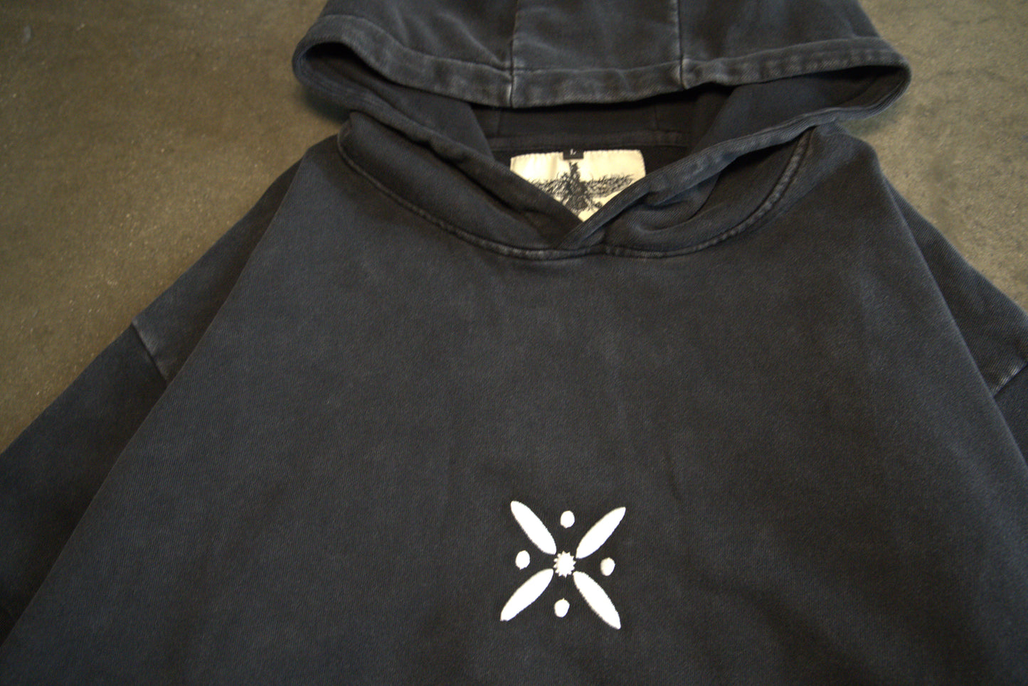 White Standard of Kaveh embroidery on front of hoodie