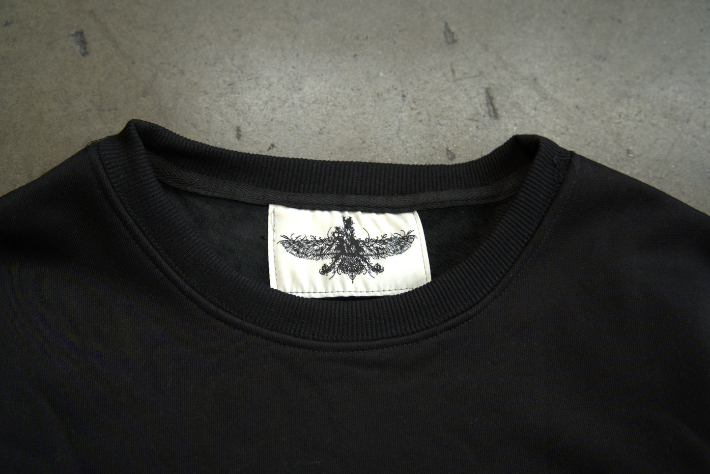 Farvahar Design tag detail on luxury crewneck