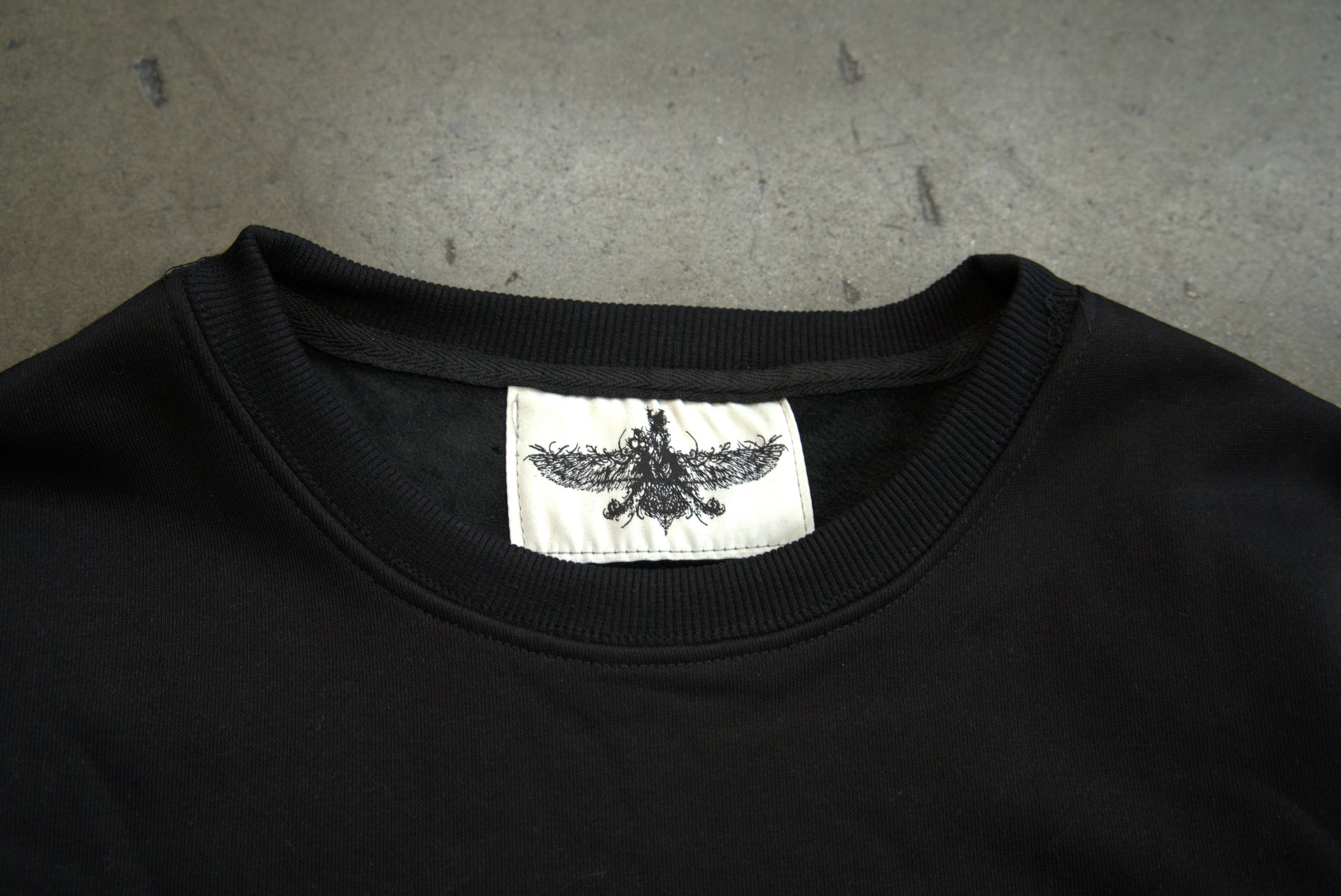 Farvahar Design tag detail on luxury crewneck