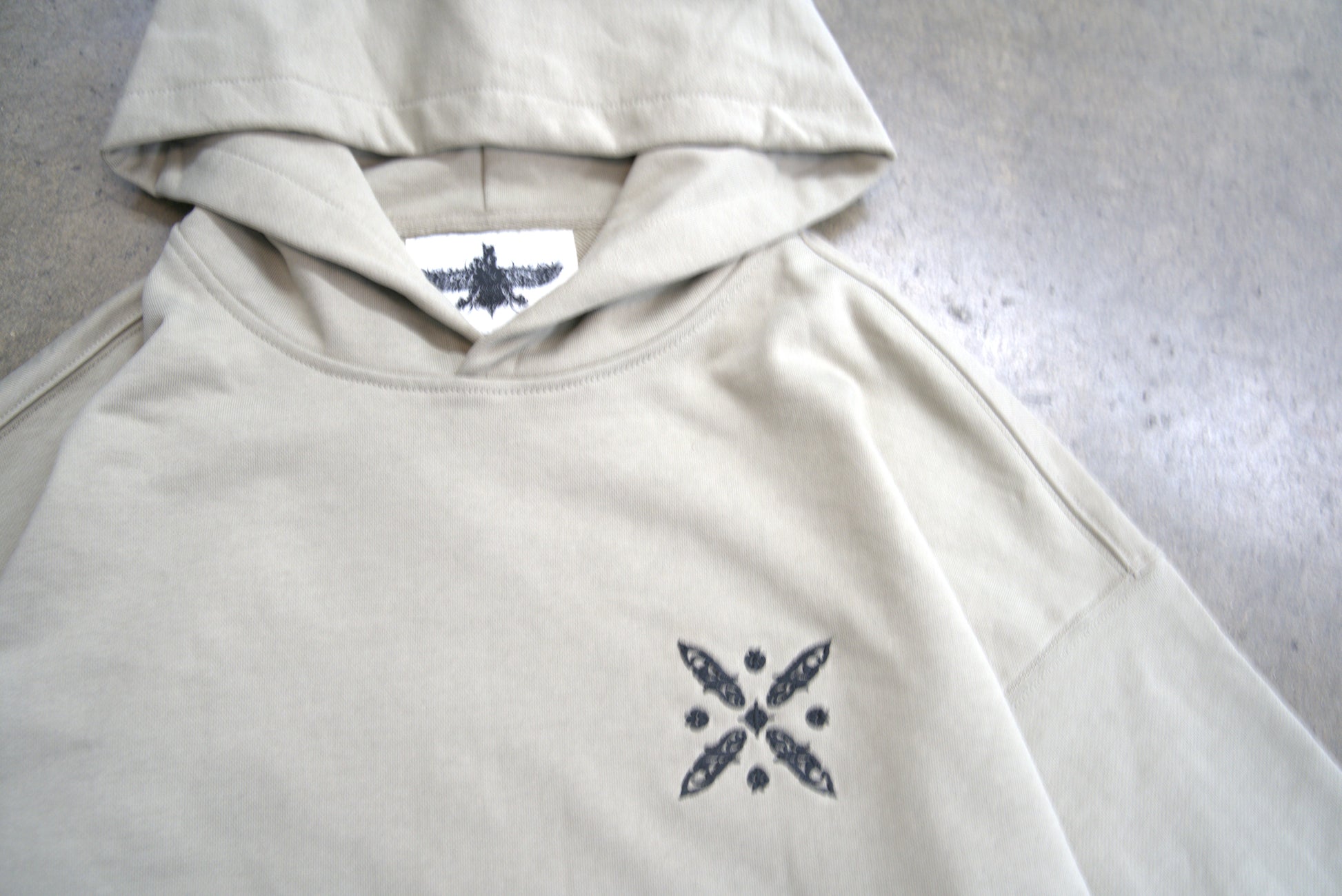 Zoroastrian symbolic embroidery details on heavyweight hoodie