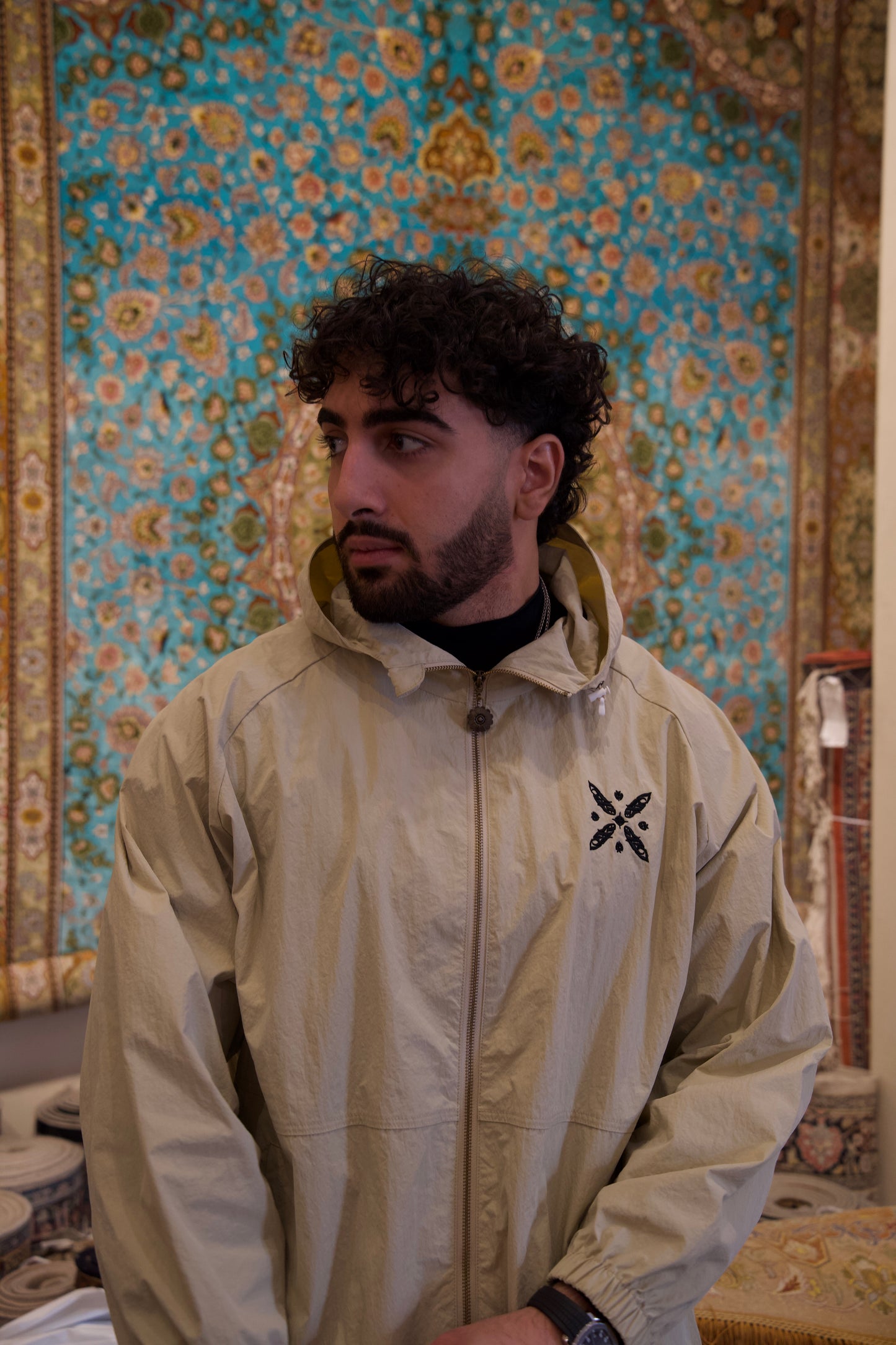 Xodafez Sassanid windbreaker Persian carpet background Kaviani emblem